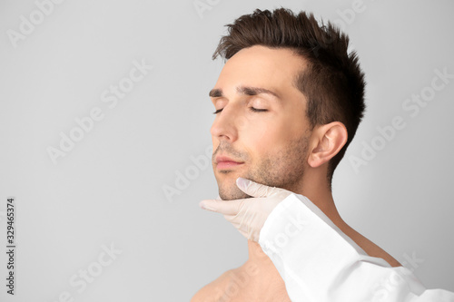 Plastic surgeon touching fa...