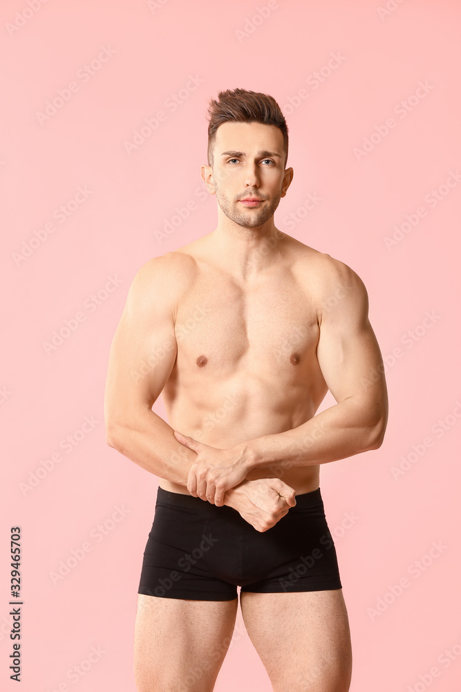 Fototapeta premium Handsome man in underwear on color background