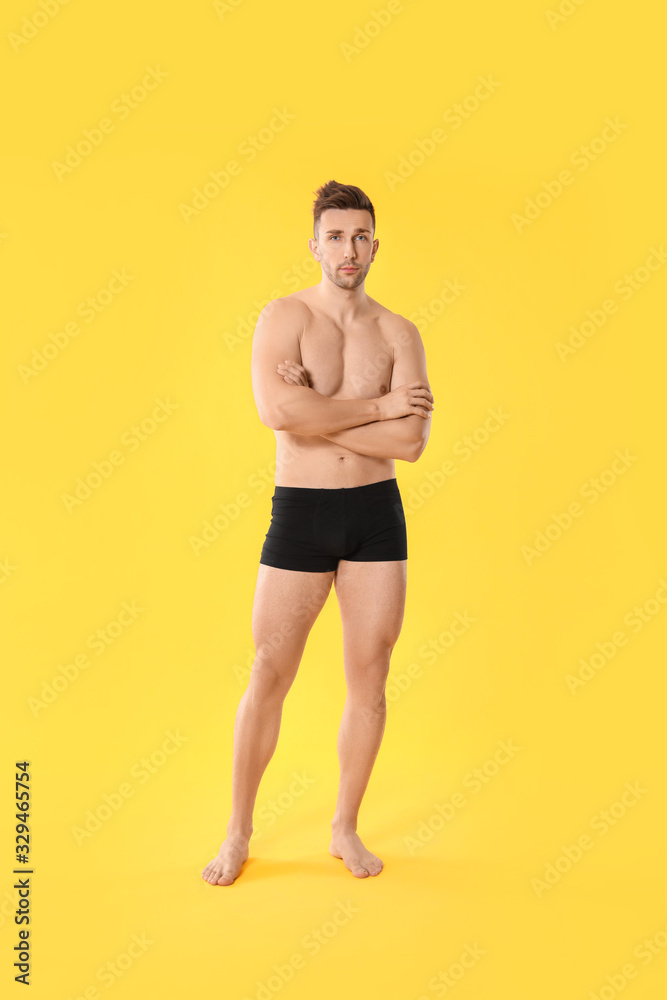 Fototapeta premium Handsome man in underwear on color background