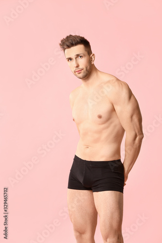 Handsome man in underwear on color background © Pixel-Shot