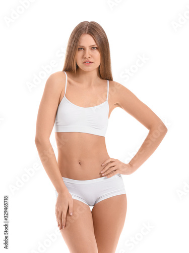 Beautiful young woman in underwear on white background