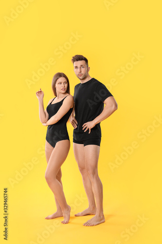 Wallpaper Mural Young couple in underwear on color background Torontodigital.ca