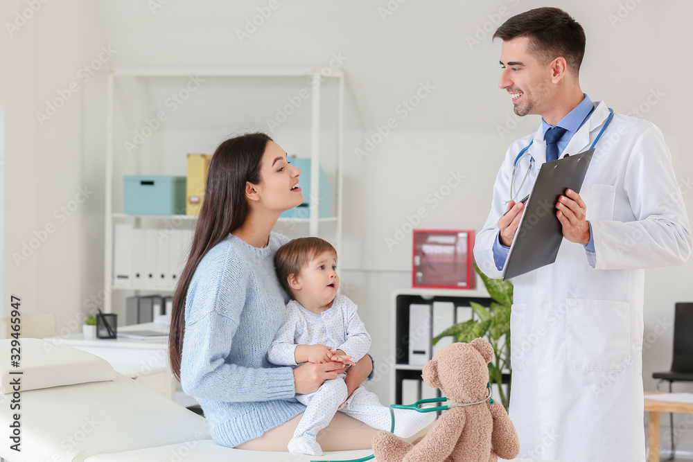 Fototapeta premium Woman with little baby visiting pediatrician in clinic