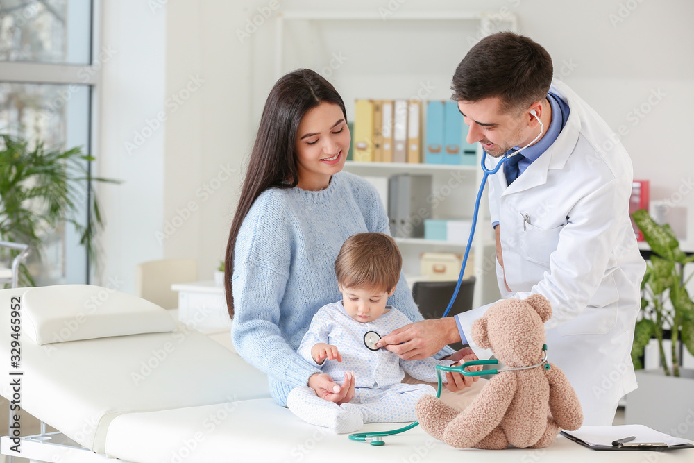 Woman with little baby visiting pediatrician in clinic Woman with little baby visiting pediatrician in clinic
