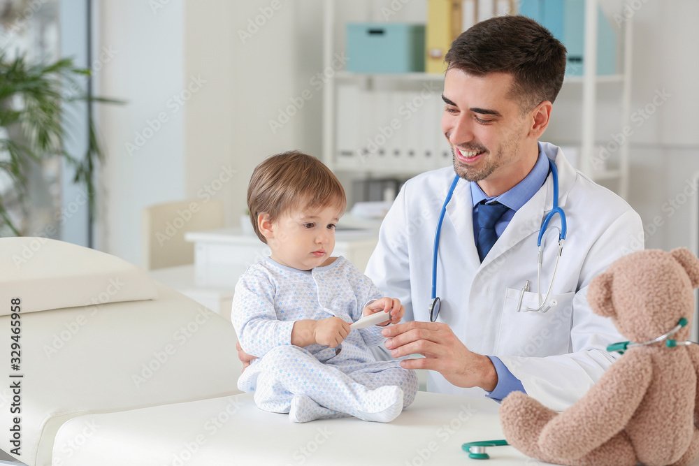 Pediatrician examining little baby in clinic Pediatrician examining little baby in clinic