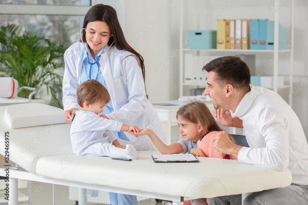 Man with children visiting pediatrician in clinic Man with children visiting pediatrician in clinic