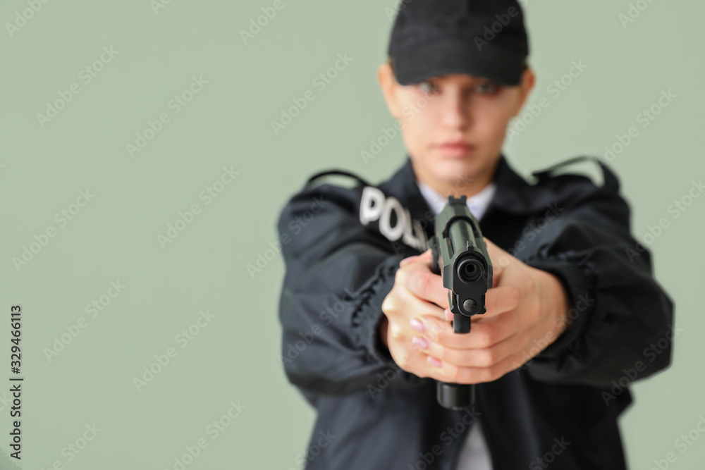 Female police officer with gun on color background Female police officer with gun on color background