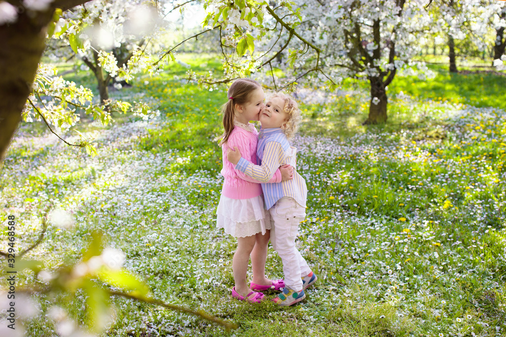 Kids with cherry blossom flower. Easter egg hunt. Kids with cherry blossom flower. Easter egg hunt.
