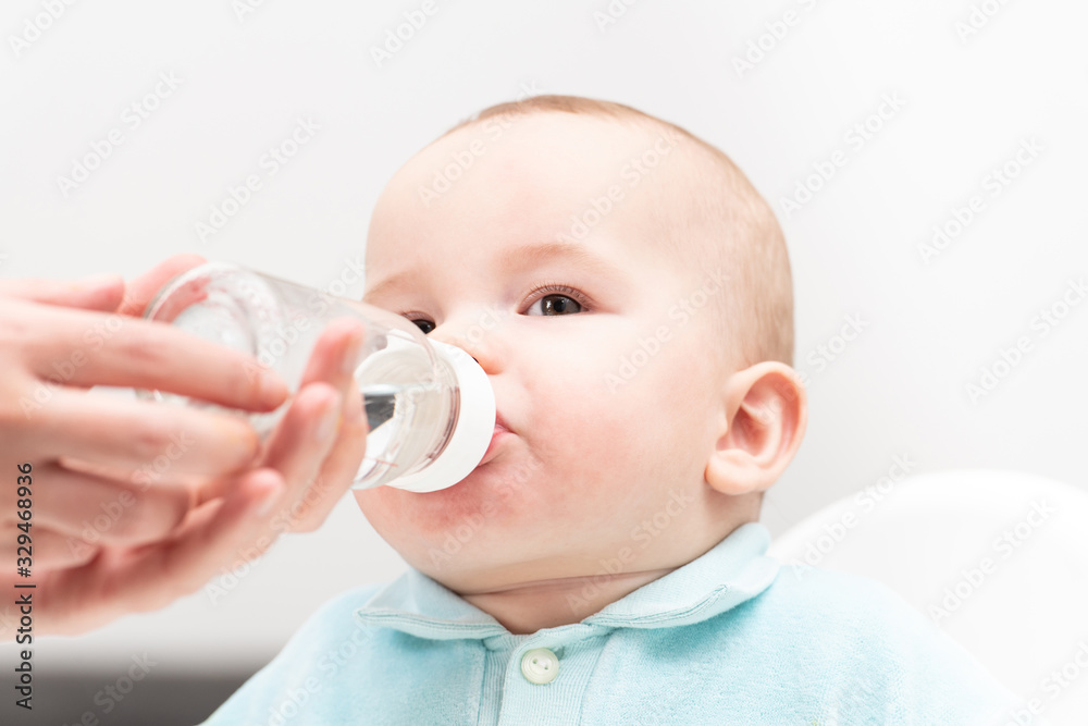 Mother Giving Baby To Drink Water From Bottle Mother Giving Baby To Drink Water From Bottle
