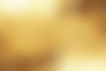 Light shining down on gold foil metal wall with copy space, abstract background