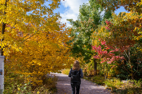 woman walking in autumn park © Marco