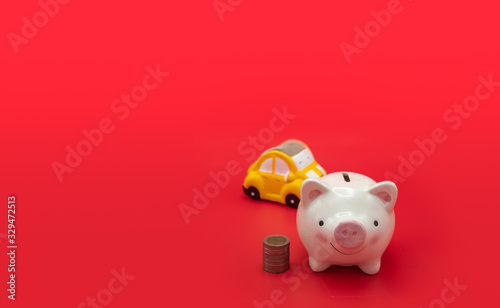 Piggybank and a pile of coins placed on a red background Represents the concept of saving