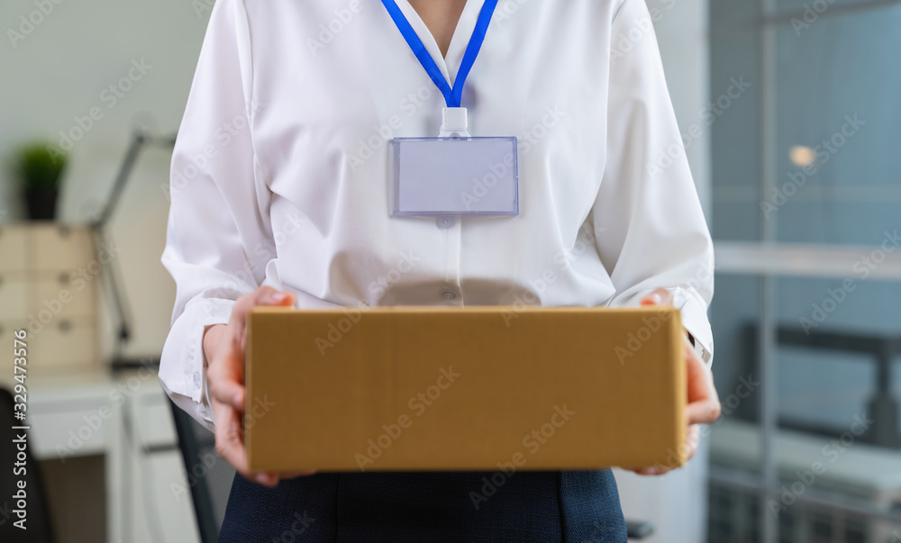 Employee holding packing box in office delivery to customer. Employee holding packing box in office delivery to customer.