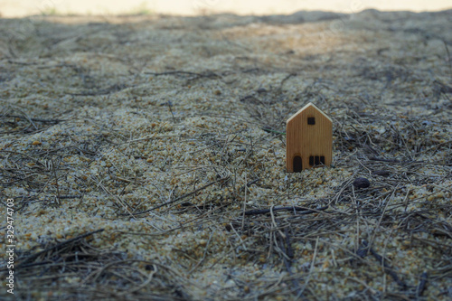 Wooden house located on the sand behind the sea