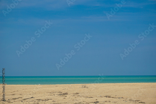 Golden sand beach has sand, sea water, sand, the sea water on the sand.