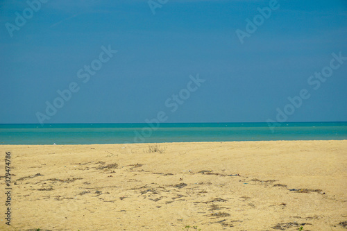 Golden sand beach has sand, sea water, sand, the sea water on the sand.
