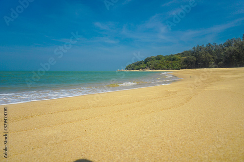 Golden sand beach has sand, sea water, sand, the sea water on the sand.