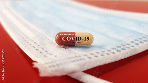 Medication of antiviral capsule(medicine) for treatment and prevention of new corona virus infection(COVID-19,novel coronavirus disease 2019 or nCoV 2019 from Wuhan on mask.Pandemic infectious concept photo