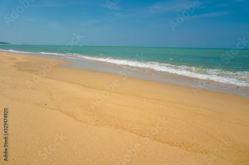 Golden sand beach has sand, sea water, sand, the sea water on the sand.