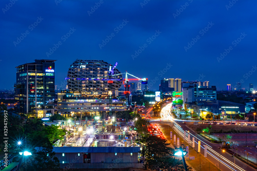 Tangerang, Indonesia - 26th Sept 2019: The scenery at Gading Serpong Boulevard at night. Long exposure photo with light trails. Gading Serpong is a luxury real estate with high property investment.