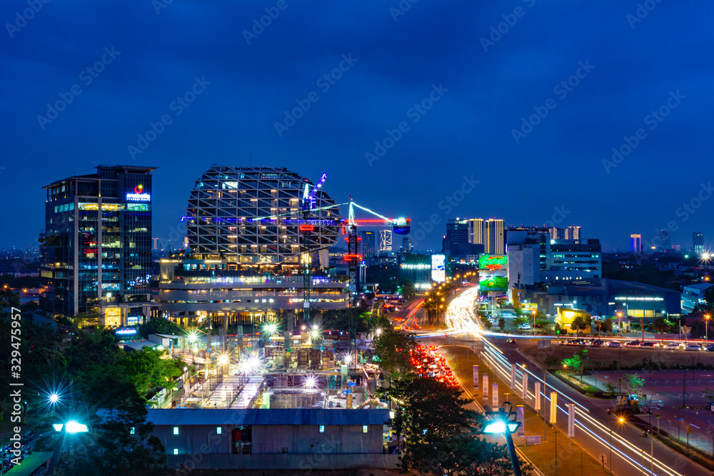 Tangerang, Indonesia - 26th Sept 2019: The scenery at Gading Serpong Boulevard at night. Long exposure photo with light trails. Gading Serpong is a luxury real estate with high property investment. Tangerang, Indonesia - 26th Sept 2019: The scenery at Gading Serpong Boulevard at night. Long exposure photo with light trails. Gading Serpong is a luxury real estate with high property investment.