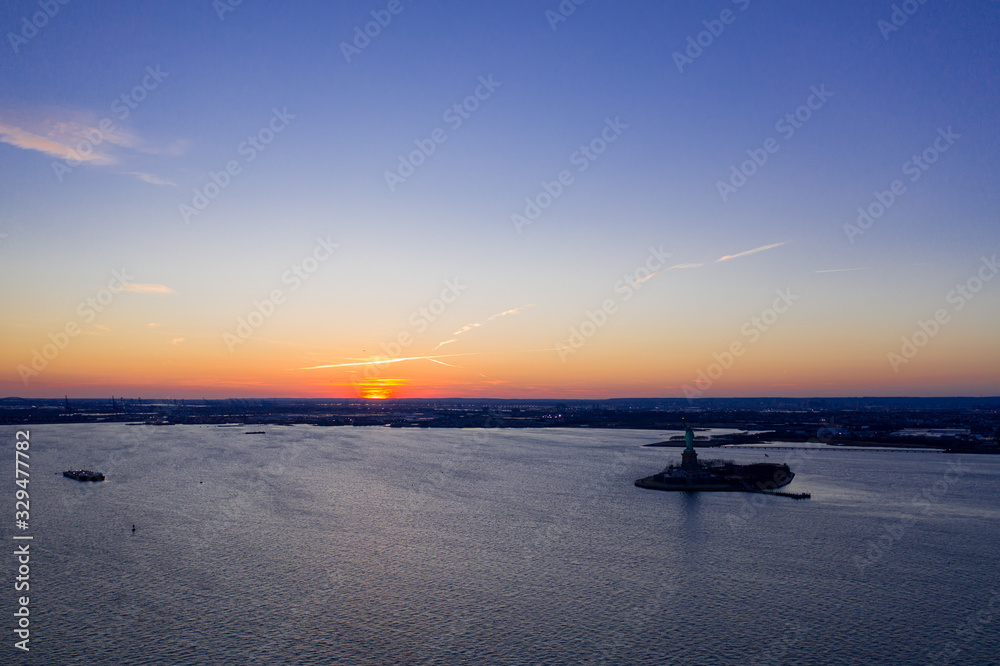 Aerial view of Liberty and Ellis Island in New York at sunset, USA