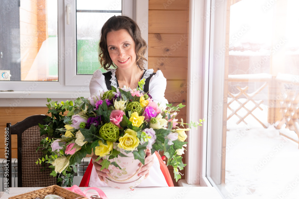 A bouquet of flowers made by a florist on a table made of wood.