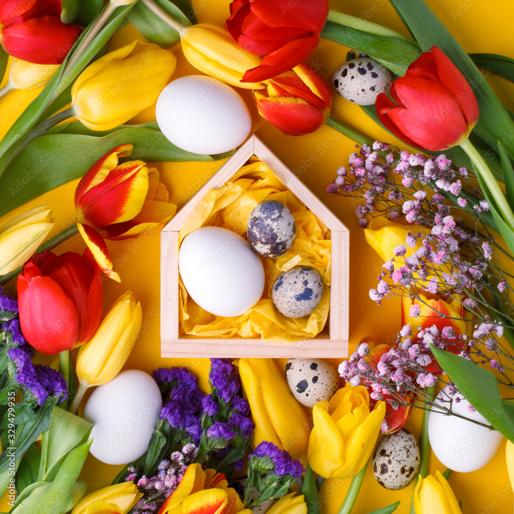 Springtime season greeting card - happy easter concept - multicolored tulips and eggs on bright yellow background, copy space, celebrate banner