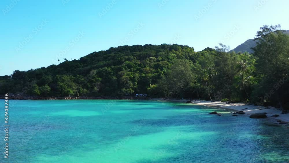 Blue azure lagoon on a paradise bay with secret sandy beach and cliffs surrounded by green lush vegetation in Thailand Blue azure lagoon on a paradise bay with secret sandy beach and cliffs surrounded by green lush vegetation in Thailand
