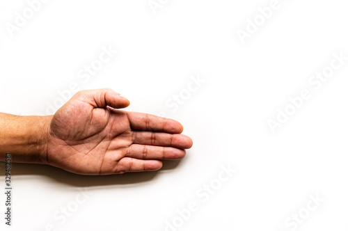 An isolated  left hand reaches in frame left with palm open  on a white background with copy space.