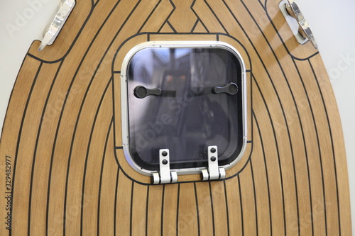 Canvastavla Brown marine teak motor yacht bow deck close up with porthole window