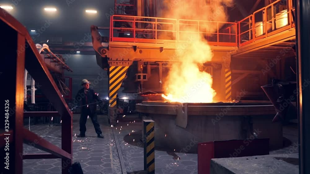 Man Working in a steel mill working in the hot manufacture