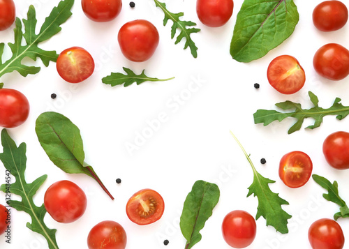 Vegetable frame with place for text: cherry tomatoes, lettuce, chard, mizuna, top view. Vegetables isolated on a white background.