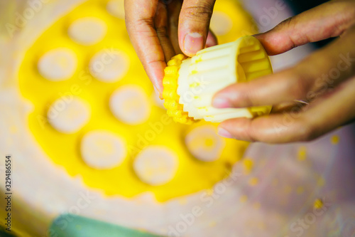 Close up of female hands making cookies from fresh dough at home