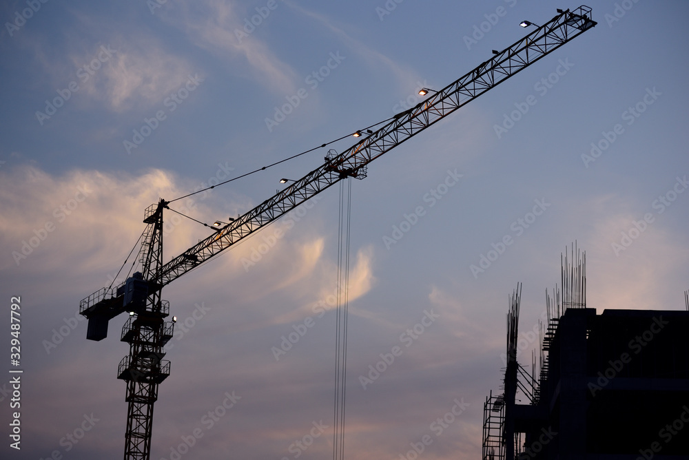 Construction building with crane over sunset time