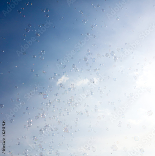 Soap bubbles fly in the blue sky