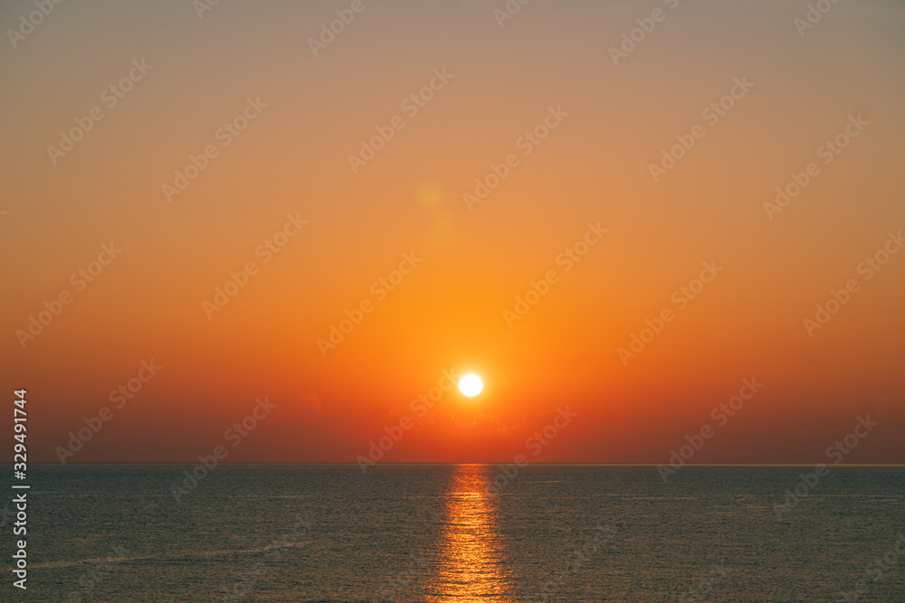 The sun rises on the sea at summer morning 