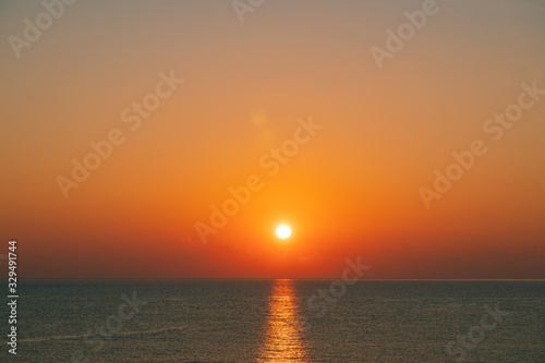 The sun rises on the sea at summer morning 