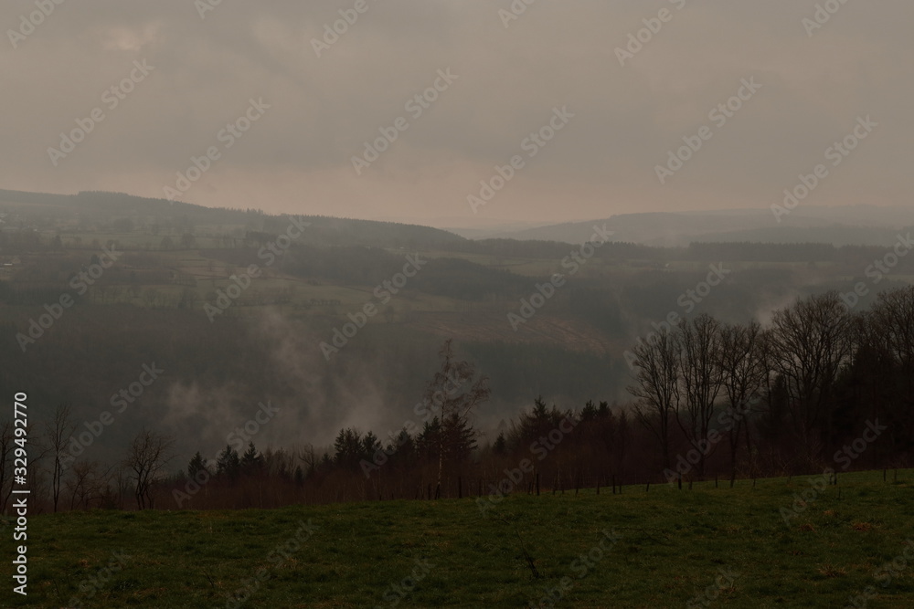 a misty morning photo of a farmers field in wallonia belgium lying in the nature reserve the belgian ardennes with a nice view of hilly landscape in the province of liège a misty morning photo of a farmers field in wallonia belgium lying in the nature reserve the belgian ardennes with a nice view of hilly landscape in the province of liège