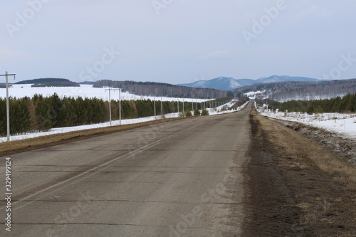 Winter paved road leading to the mountains