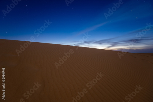 night dramatic sky over sandy desert before sunrise