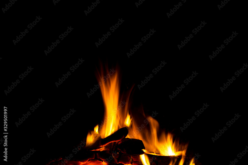 Burning wood logs in the fireplace close up. Barbeque fire. Charcoal and burning wood background. Fire background texture Burning wood logs in the fireplace close up. Barbeque fire. Charcoal and burning wood background. Fire background texture