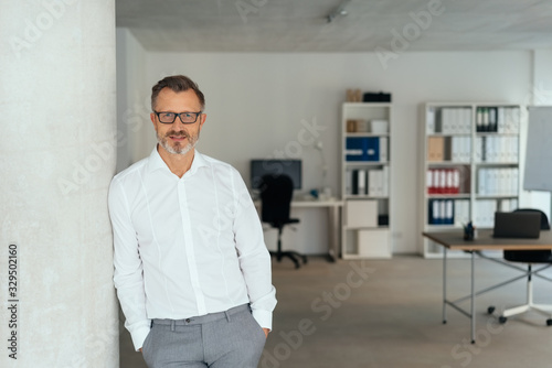 Relaxed successful businessman in spacious office