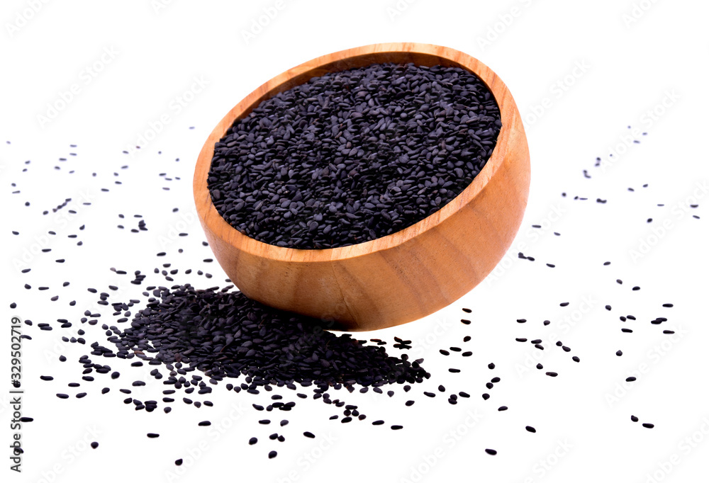 Black sesame in a wooden cup isolated on white background Black sesame in a wooden cup isolated on white background
