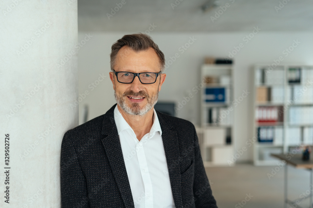 Attractive middle-aged businessman in the office Attractive middle-aged businessman in the office