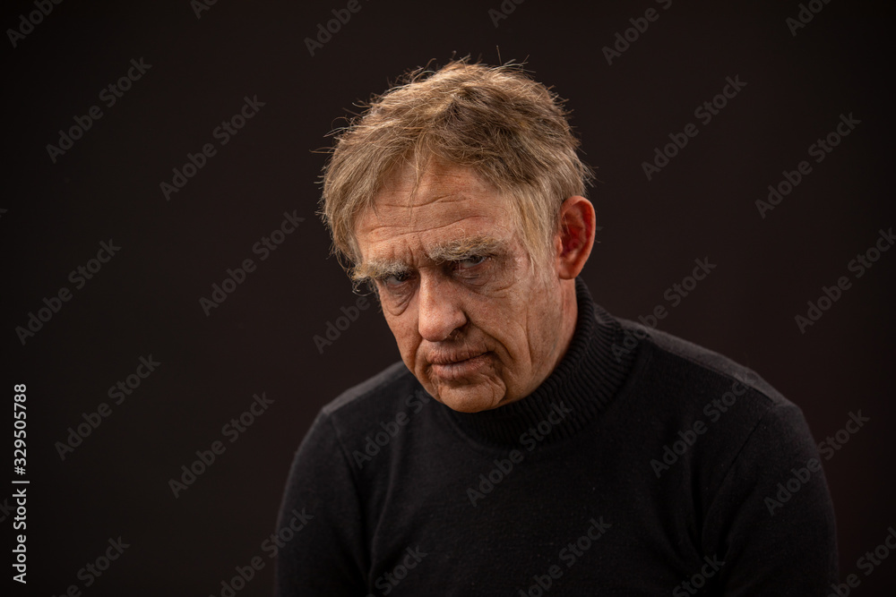 plastic makeup. makeup for cinema. old man on a black background plastic makeup. makeup for cinema. old man on a black background
