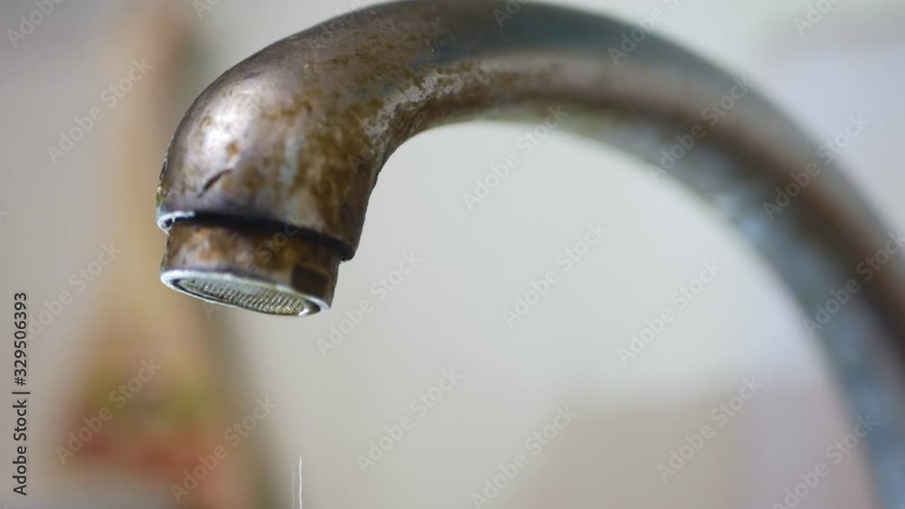 dripping old, rusty kitchen faucet. water dripping from a tap close up. Lack of clean water, reckless use of resources
