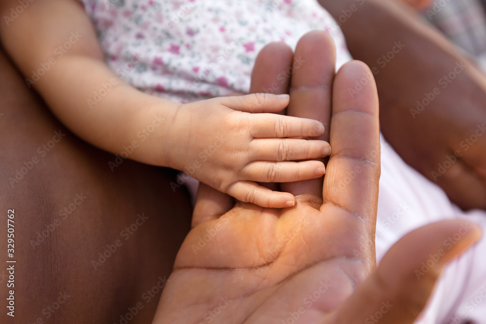 Father and daughter holding hands, family and happiness concept Father and daughter holding hands, family and happiness concept