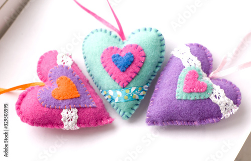 Toys made of felt on a white background, colored heart