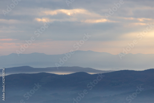 Sea of fog and mist between layers of mountains and hills © Massimo